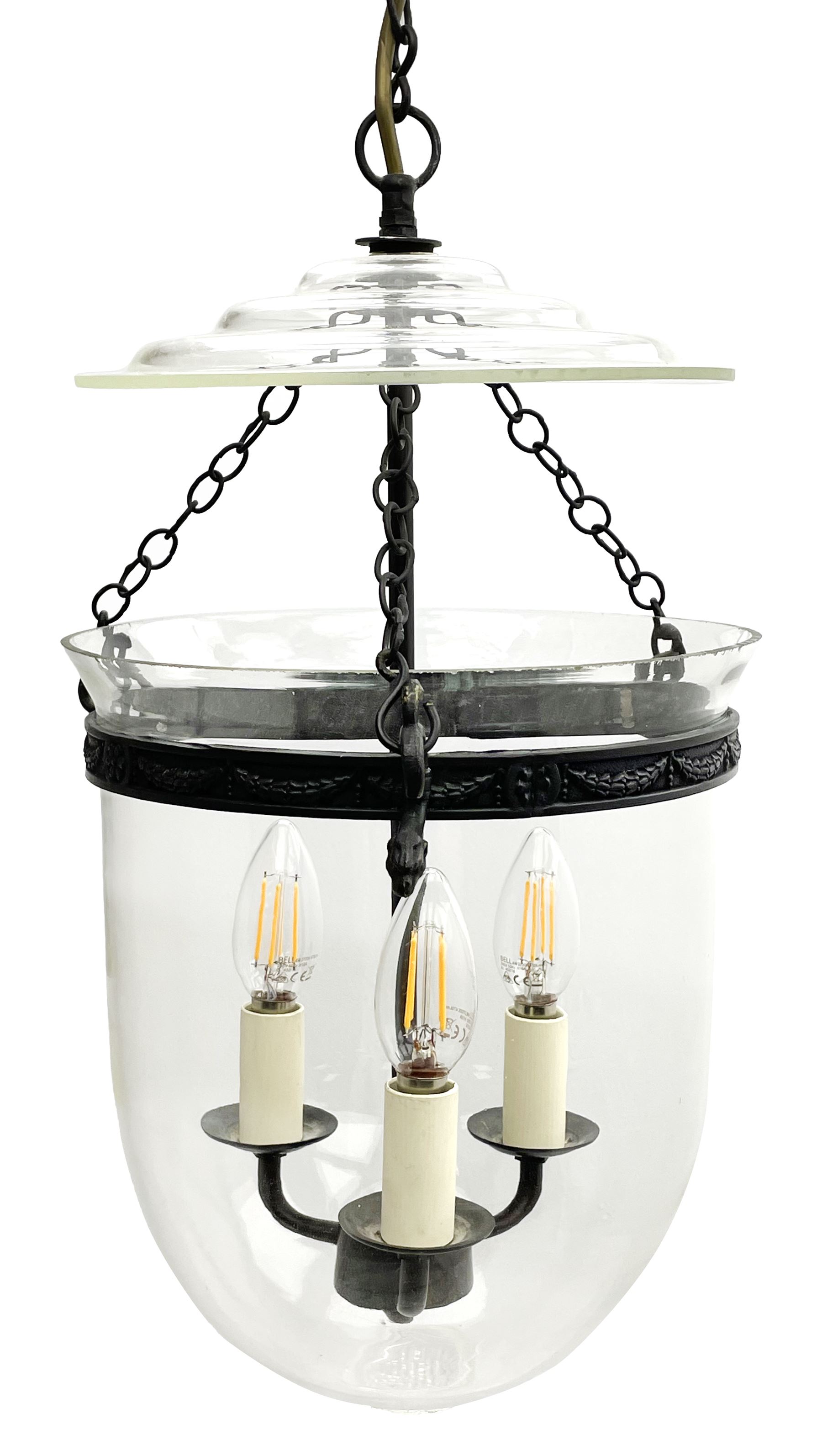 Vaughan Designs - Regency design bronzed metal and glass hall lantern, three branch light in glass bell, the band decorated with bell flower garlands and serpentine mythical beast chain brackets