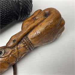 19th century wooden walking stick, the handle carved as a snake within a clenched fist, the cane carved with foliate and cross hatched decoration, with a metal spike to base, together with a turned wooden walking stick, with lacquered rope nautical knot handle, tallest L96.5cm