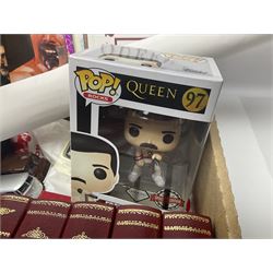 Mostly Queen and Freddie Mercury interest items, including pin badges, newspaper cuttings, diecast 'promotional' vehicles, special edition Pop Rocks figure of Freddie Mercury, VHS tapes, two charity certificates signed by Brian May and Roger Taylor, poster etc, in two boxes 