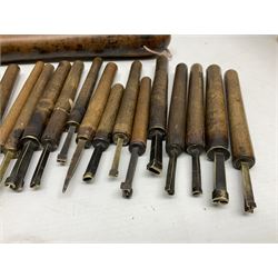 Thirty-one bookbinder's brass number and letter stamps, predominantly with beech handles, together with a bookbinder' decorative fillet roll, with brass triple line wheel stamped E. Menuel London, with wood handle, and two ink blotters