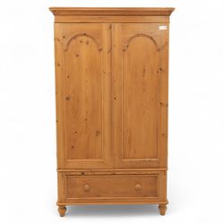 Two contemporary traditional-style wardrobes, projecting plain cornice above two arched moulded panel doors, above a full-width drawer fitted with turned wooden handles, raised on turned bun feet