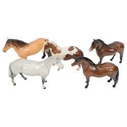 Five Beswick horses, including Skewbald Pinto no 1373, Dartmoor 1642, Dunn Highland no 1644 etc