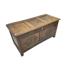 18th century oak blanket chest or coffer, rectangular hinged top with three panels and moulded edge, frieze carved with lunette and acanthus leaf decoration, two front panels carved with scrolling motif, raised on stile supports