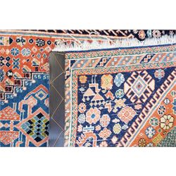 Small Afghan rust ground rug, plain field enclosed by patterned borders (94cm x 64cm); small Persian Hamadan indigo ground rug, decorated all-over with small flower head and bird motifs (118cm x 66cm); and a small Persian red ground rug (94cm x 62cm) (3)