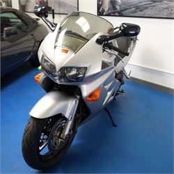 1998 Honda VFR800 FI Sports Touring Motorcycle

• Registration: R145 SUT
• Date of first registration: 1998
• Engine: 781cc V4 petrol
• Fuel system: Honda PGM-FI fuel injection
• Transmission: Manual
• Odometer reading: 11,700 miles
• Colour: Silver with black trim
• V5C: Present
• Keys: Two
• Security: Datatag immobiliser

A well-presented 1998 Honda VFR800 FI sports touring motorcycle, finished in silver with contrasting black trim and displaying a notably low odometer reading of 11,700 miles.

The VFR800 combines Honda’s renowned V4 engine with PGM-FI fuel injection and a combined braking system, creating a capable and refined motorcycle suited to both sporting and long-distance use.

Features include:

• Full factory fairing
• Tinted windscreen
• Honda PGM-FI fuel injection
• Combined braking system
• Twin front brake discs
• Factory exhaust system
• Alloy wheels
• Rear passenger grab handles
• Datatag immobiliser
• Digital instrument display

The motorcycle appears complete and largely original and has been stored indoors. It is presented in good overall condition, with light cosmetic marks consistent with its age and use.

This vehicle forms part of the Estate of the Late John Sils and is offered for sale by the Executors, confirming a genuine reason for sale.
