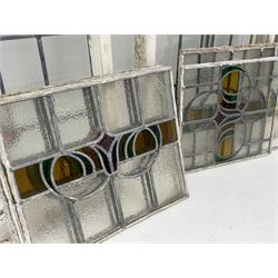 Collection of stained and leaded glass windows and panes, stylised floral design, various sizes, the largest window measuring 55cm x 112cm (including wooden frame)