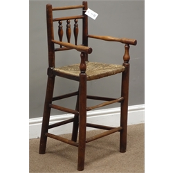  18th century elm and fruitwood child's high chair, spindle back, rush seat, well worn foot stretcher, H81cm  