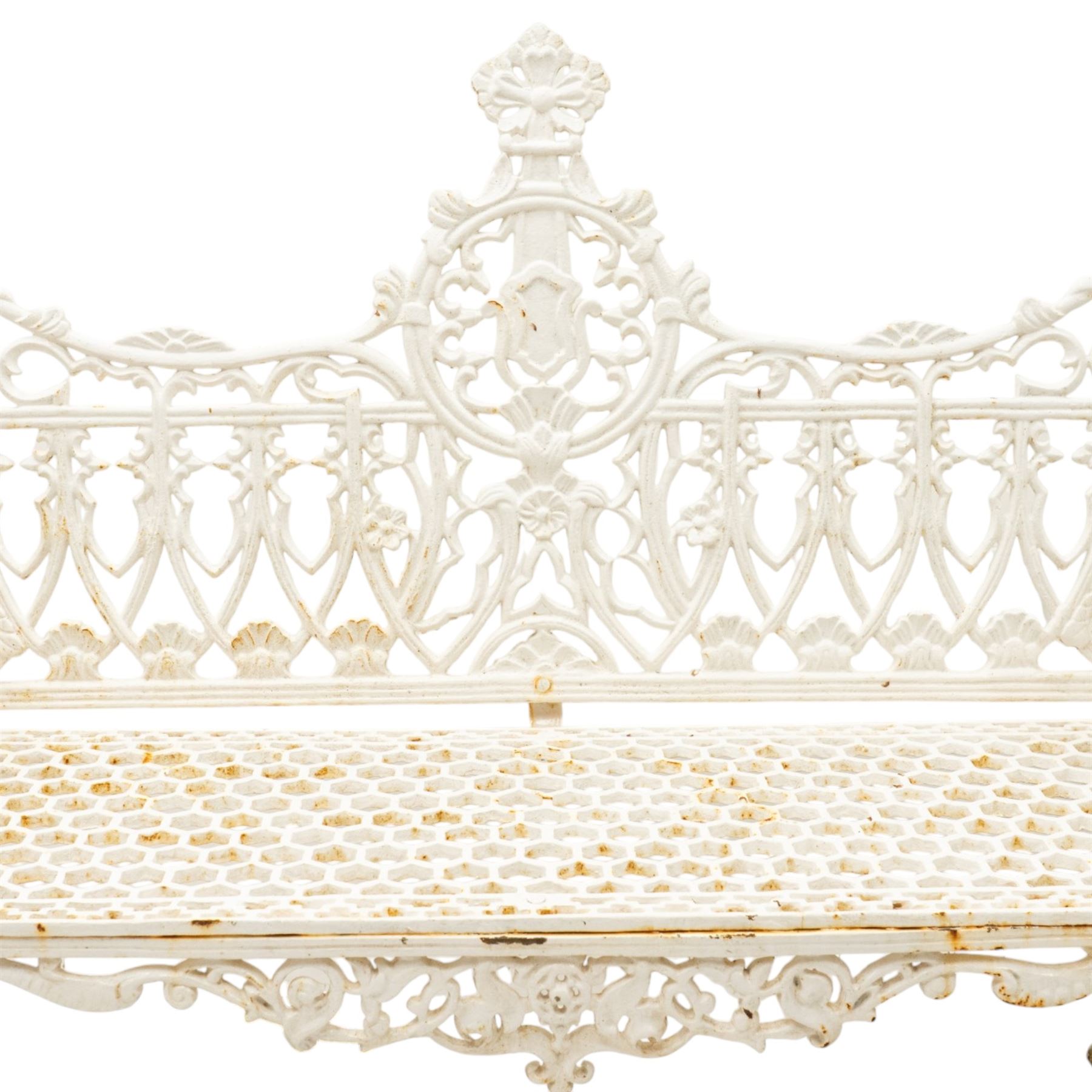 Victorian revival heavy cast iron garden bench, ornate back rest with scrolls, floral motifs and central crest, pierced lattice seat, curved arms and decorative legs, painted in antique white, in the Gothic Coalbrookdale style