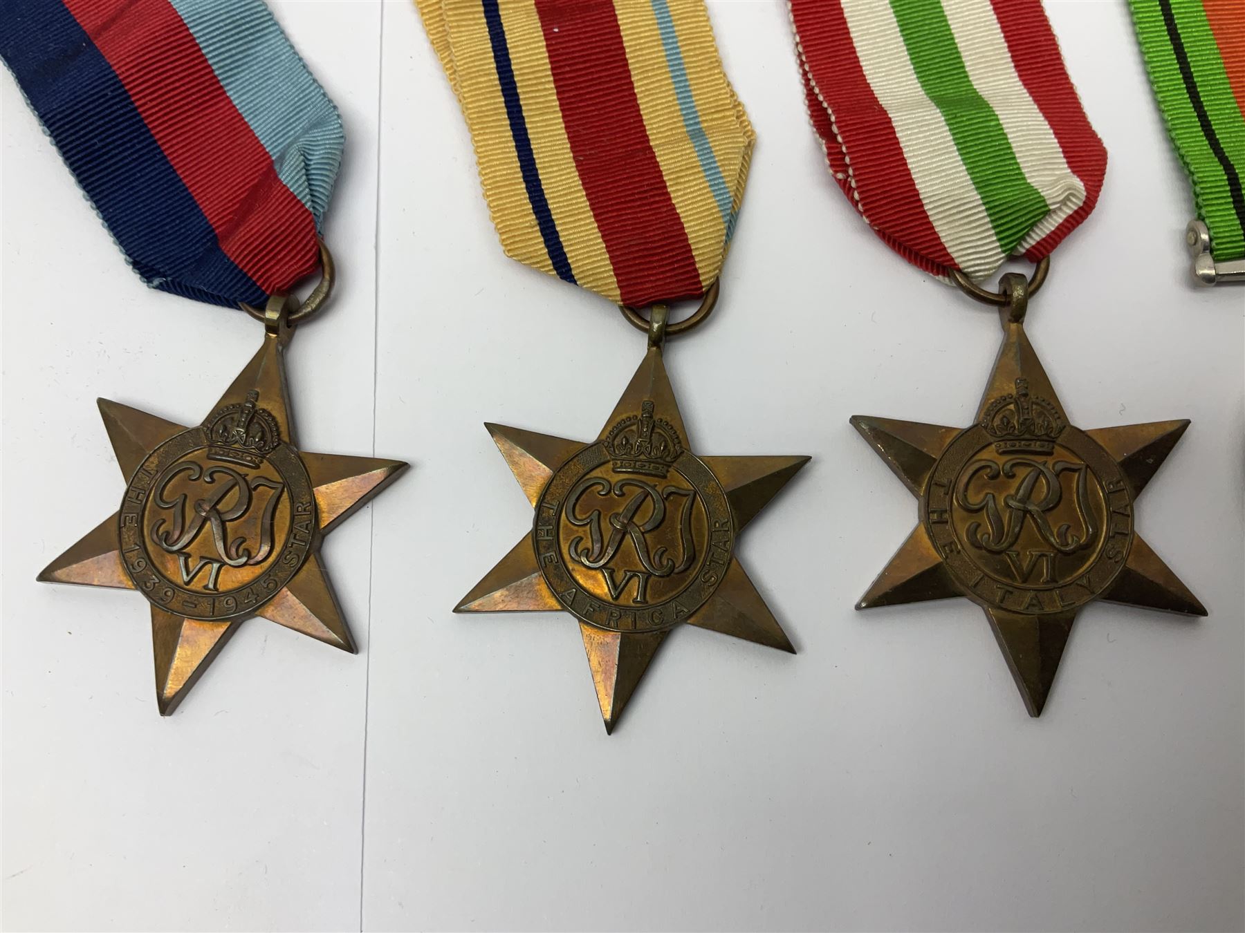 WWI pair of medals comprising British War Medal and Victory Medal awarded to 32682 Pte. W. Meadows W. Rid. R. in issue box; WWI pair of medals comprising 1914-15 Star and Victory Medal awarded to 3720 Pte. (later Cpl.) E. Petty W. York. R. with issue letter from Tank Corps; WWII group of five medals comprising 1939-45 War Medal, Defence Medal and 1939-45, Italy and Africa Stars; all with ribbons; and book of nineteen seaman's Certificates of Discharge to cook Charles Filburn 1893 - 1901 from various British ports