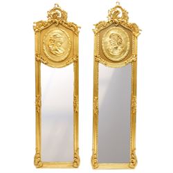 Pair of Rococo Revival gilt framed wall mirrors, the pierced scrolling rocaille pediment w...
