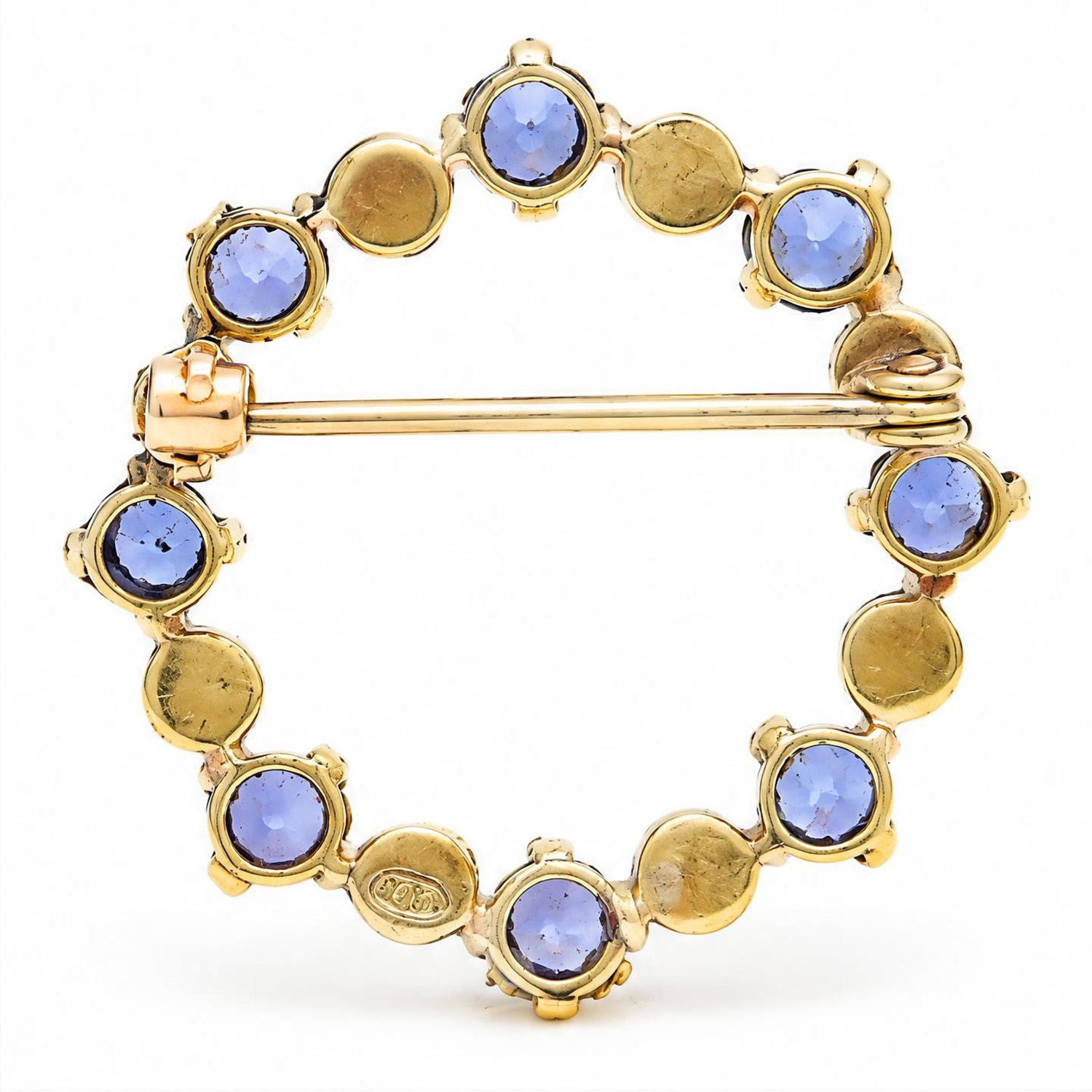 Early 20th century 15ct gold sapphire and pearl circular brooch, set with alternate round cut sapphires and split pearls, stamped 15