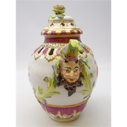  Late 19th/ early 20th century Berlin porcelain pot pourri vase and cover, painted with putti and floral vignettes, two mask and leaf moulded handles below a floral encrusted finial, underglaze blue scepter mark, H29cm   