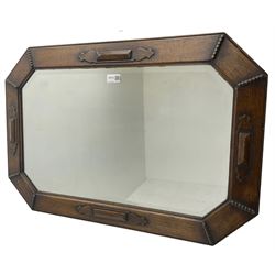 Early 20th century oak framed wall mirror, canted rectangular frame with applied rectangular cartouches and beading, bevelled mirror plate