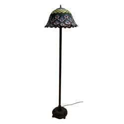 Tiffany style standard lamp, peacock feather lead and coloured glass shade, reeded stem on circular base cast with flower heads and scrolls
