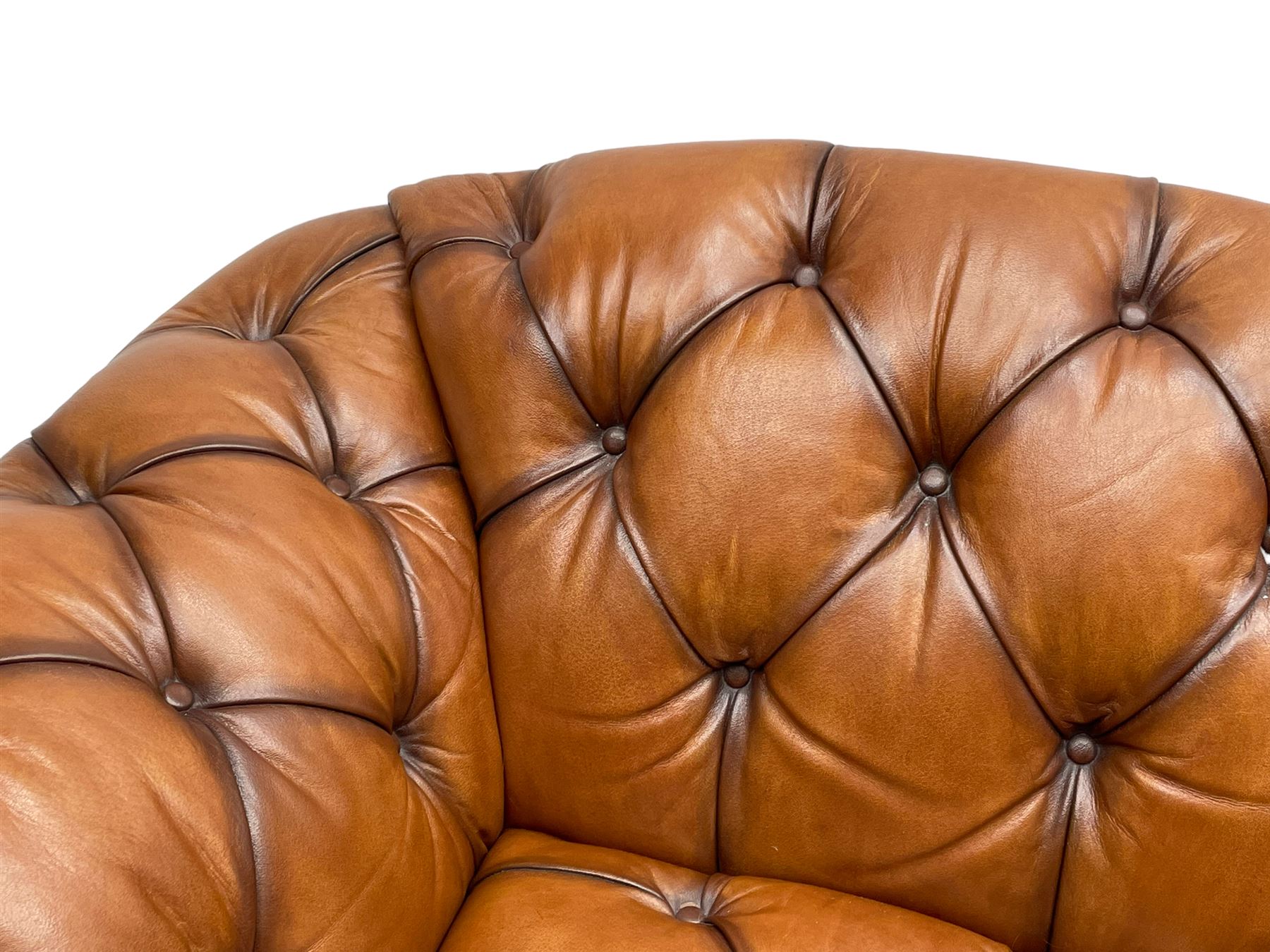 Tetrad - 'Oskar' armchair, Chesterfield shape with rolled arms, upholstered in buttoned tan leather, on turned and reed moulded feet 