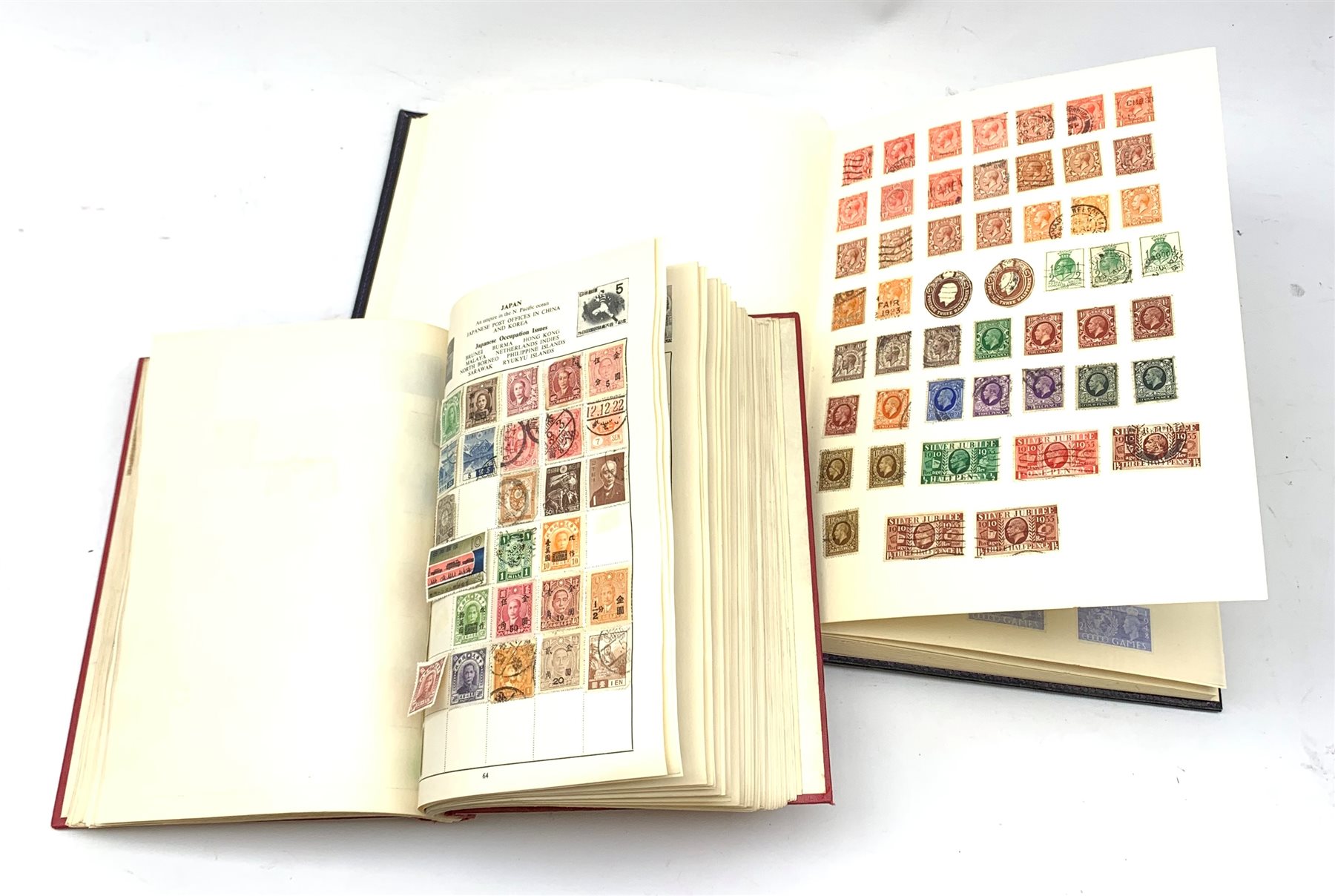 Two albums of world stamps, comprising The Cardinal Stamp Album, together with a further larger album, each containing Queen Victoria stamps.