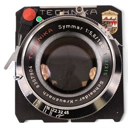 Linhof Tecnika 70 medium format press camera serial no. 1711919, with a Xenotar 1:2.8/80 lens serial no. 9254350 and a Symmar 1:5.6/180 lens serial no. 8357904, both coupled to the camera, and additional accessories including Symmar-S 5.6/100 lens, and a Carl Zeiss Jena Apo-Lanthar 40mm1:4.5 macrolens, numbered set of seven Linhof dark slides, super rollex roll film holder and anatomical grip, all contained within modern case
