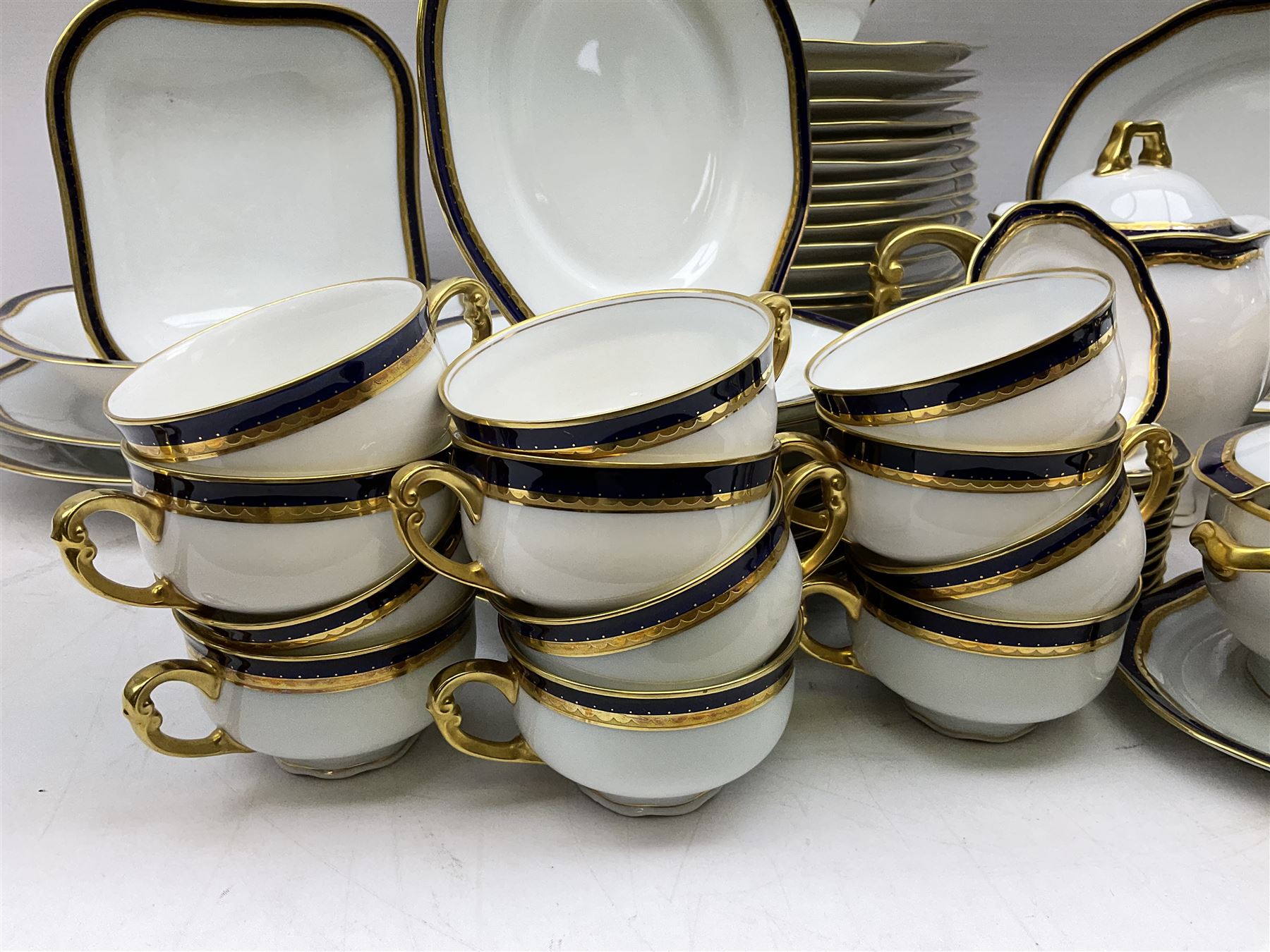 Pirkenhammer of Czechoslovakia Carlsbad pattern tea and dinner for twelve place settings to include dinner plates, soup bowls, side plates, covered tureen, tea cups and saucers, coffee cups and saucers, teapot, milk jug, covered surier, etc, with an addition twelve dinner plates (110)