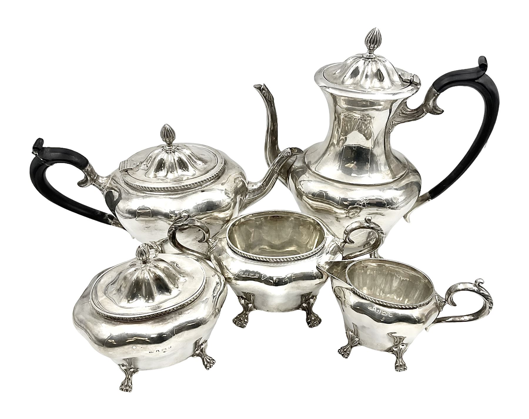 Five piece Edwardian silver tea service, comprising teapot and coffee pot, each with ebonised scroll handle, tea caddy with hinged cover, twin handled open sucrier, and milk jug, each of rounded bombe form, upon four paw feet, hallmarked William Adams Ltd, Birmingham 1904 and 1905, coffee pot H26cm
