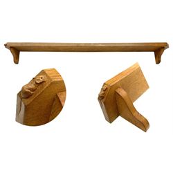 'Mouseman' oak wall shelf, canted rectangular top on shaped bracket supports, carved with mouse signature with trailing tail, by Robert Thompson of Kilburn