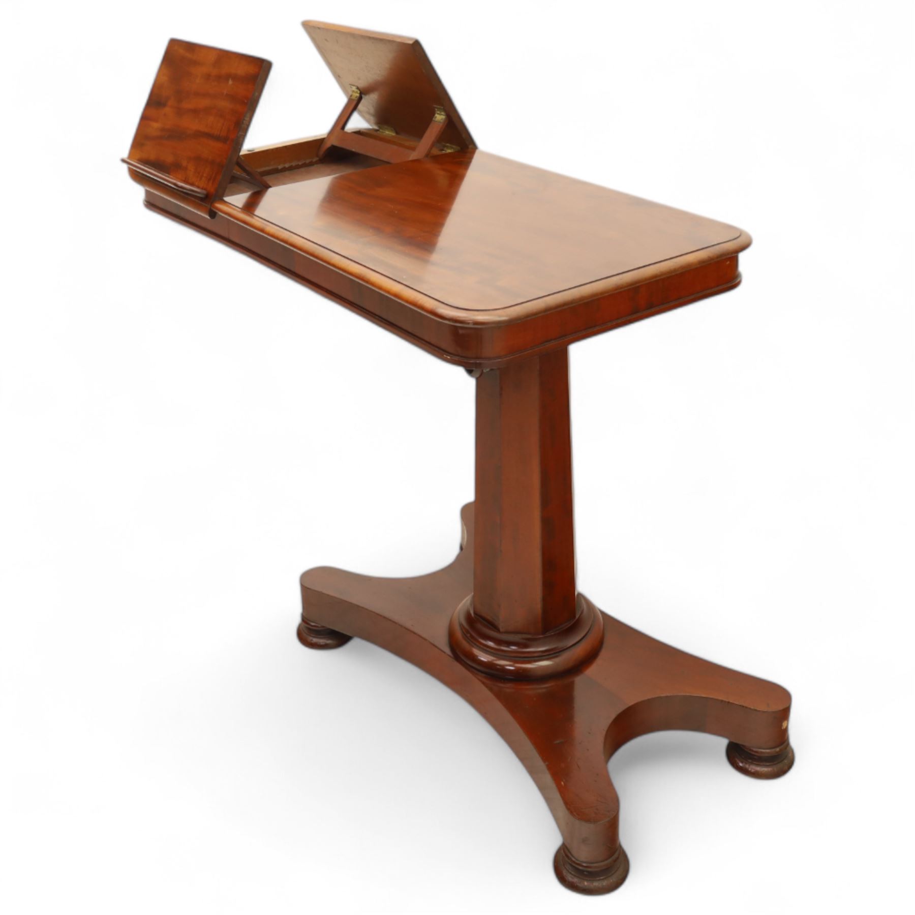 William IV mahogany reading table, the rectangular top with rounded corners and moulded edge, one end fitted with two hinged adjustable reading slops with two rests, the sliding top with a sprung stay mechanism, supported on a single tapered faceted column  with turned collar on a quatreform base with compressed bun feet