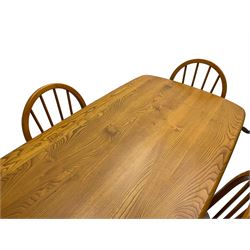 Ercol - model 382 light elm and beech dining table, rectangular plank top raised on tapering supports (W150cm D75cm H72cm); with set of four hoop and spindle back chairs