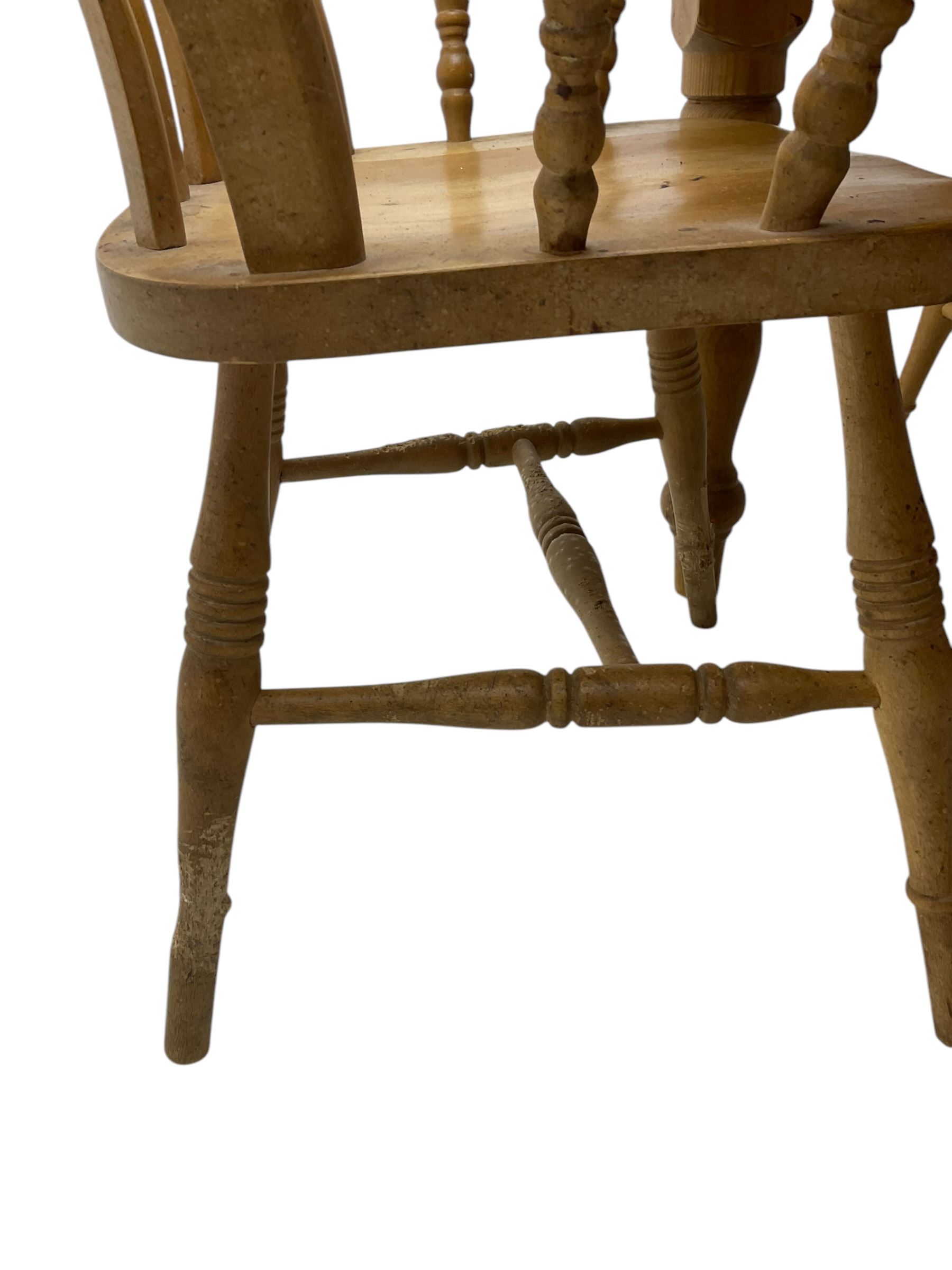 Pine farmhouse dining table, rectangular top with rounded corners, raised on turned supports; together with a set of six (4+2) spindle-back dining chairs
