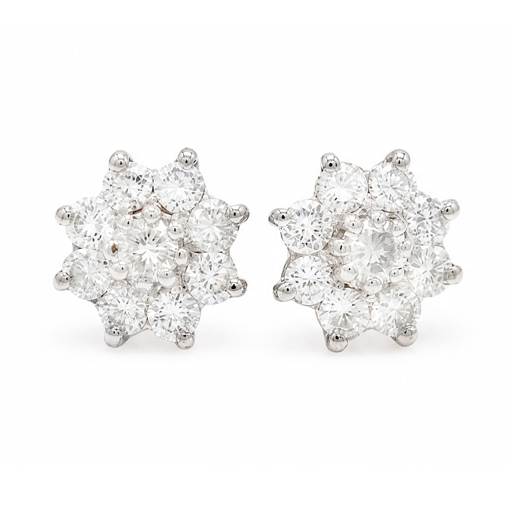 Pair of 18ct white gold diamond flower head earrings, each stud set with nine round brilliant cut diamonds, Birmingham 1996, total diamond weight approx 1.20 carat