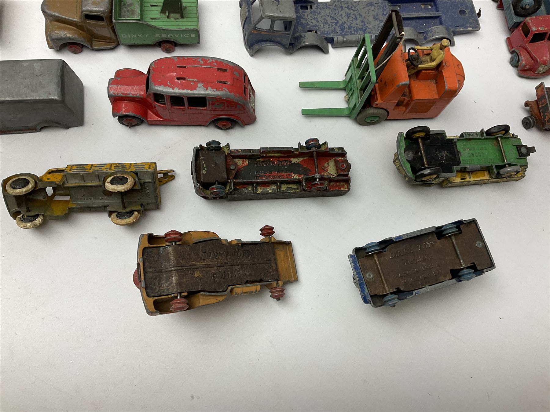 Dinky - twenty-six unboxed and playworn die-cast models including Foden Regent Tanker, two Foden lorries, Pressure Refueller No.642, Snow Plough, Elevator Loader, Foden Dump Truck, Blaw Knox Bulldozer and other commercial vehicles