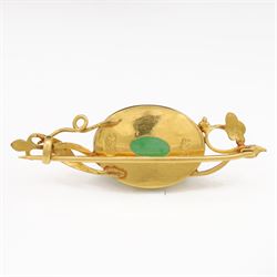 21ct gold jadeite brooch, oval cabochon cut jadeite in a floral setting
