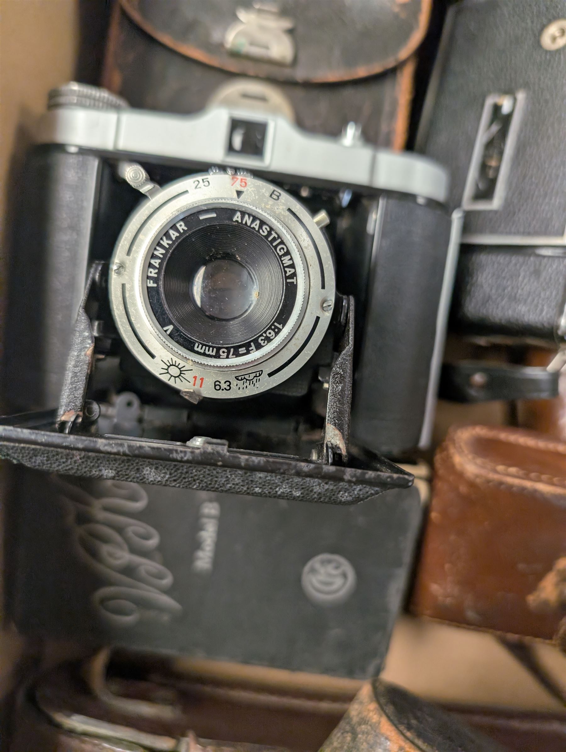 Twelve folding cameras and similar, including Afga, Jiffy Kodak, Solida Jr examples, together with light meters, Polaroid camera and other camera accessories