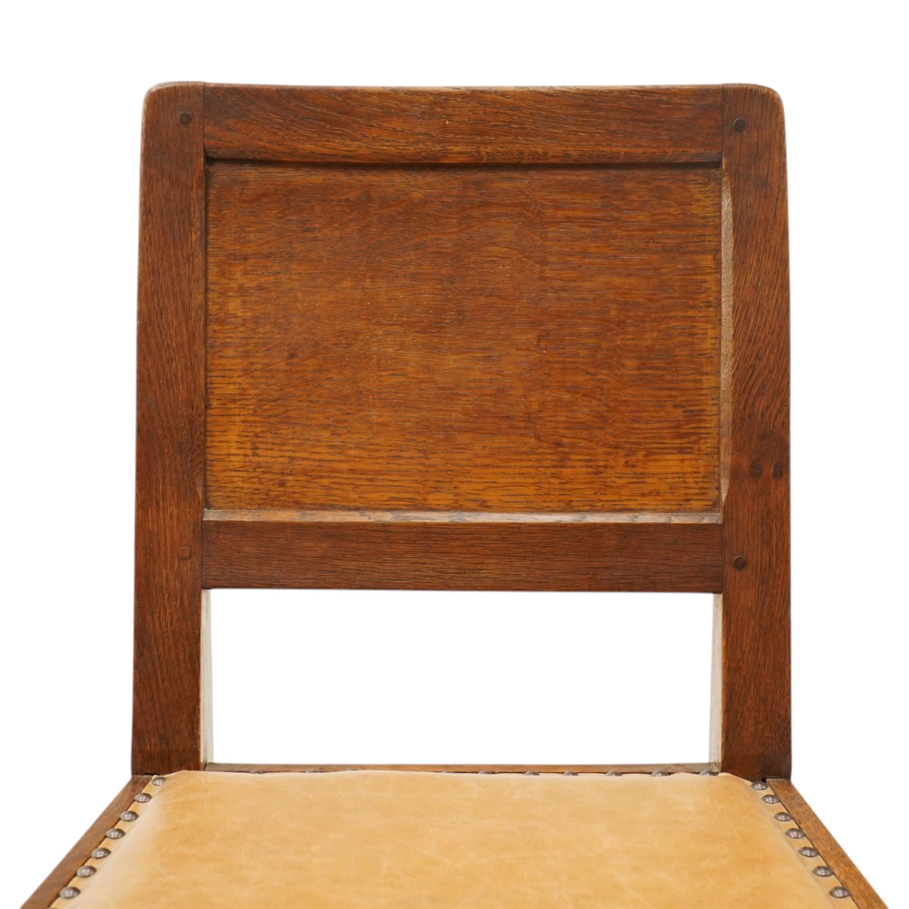 Mouseman side chair- panelled adzed back over tan leather upholstered seat with studwork, on octagonal front supports united by stretchers, each with signature carved mouse, by the workshop of Robert Thompson, Kilburn
