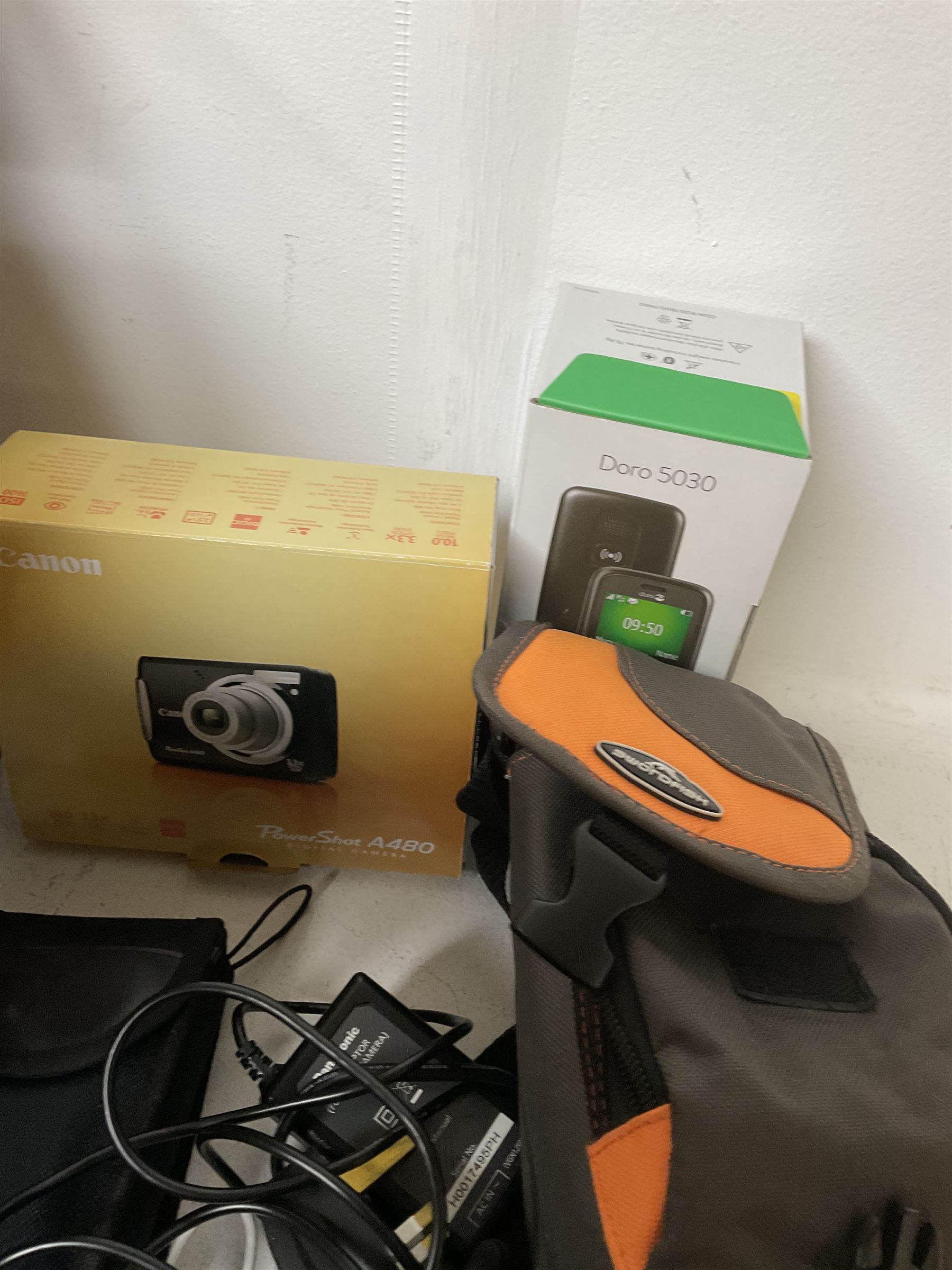 Canon Powershot A480 digital camera, in box, together with a Panasonic SDR-H86 digital video camera, Doro 5030 mobile phone, pair of Jessops Field Binoculars, two Weetabix diecast model cars, wicker picnic basket with plastic picnic ware and a collection of vinyl records