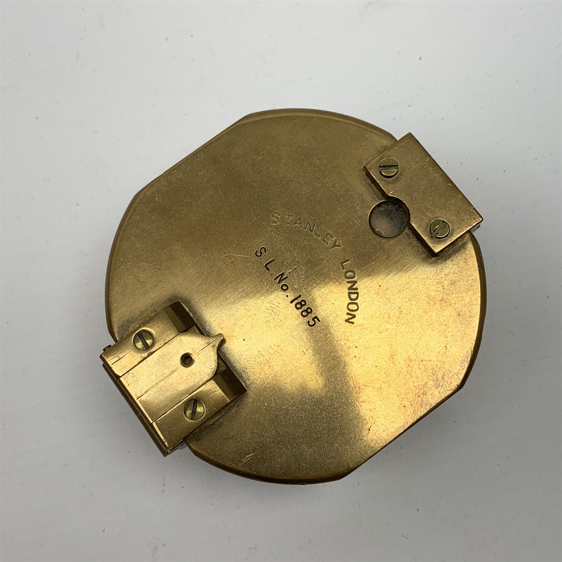 Brass Natural Sine type compass with spirit levels to the dial, bears name of Stanley, D8cm, in earlier mahogany box; brass pocket sextant of drum shaped form, the screw top marked Stanley London; small brass cased compass with pedestal tripod base; and Glass Developments Ltd. hahogany and brass spirit level L31cm (4)