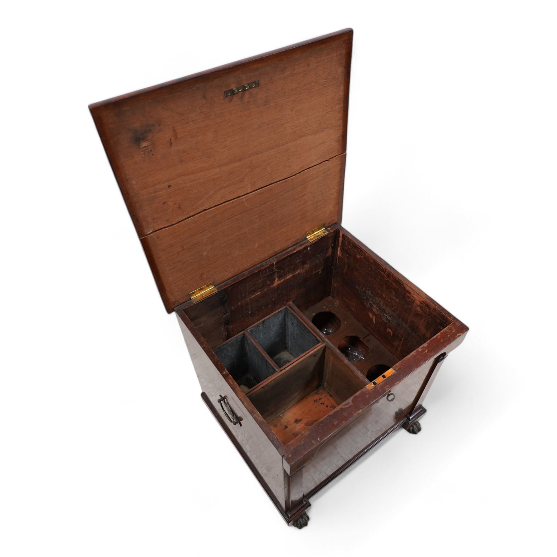 William IV mahogany cellarette, the rectangular hinged sarcophagus top enclosing bottle dividers and metal liner, the front applied with flanking flat pilasters, fitted with pressed brass handle plates escutcheon, lower moulded edge over brass hairy paw feet