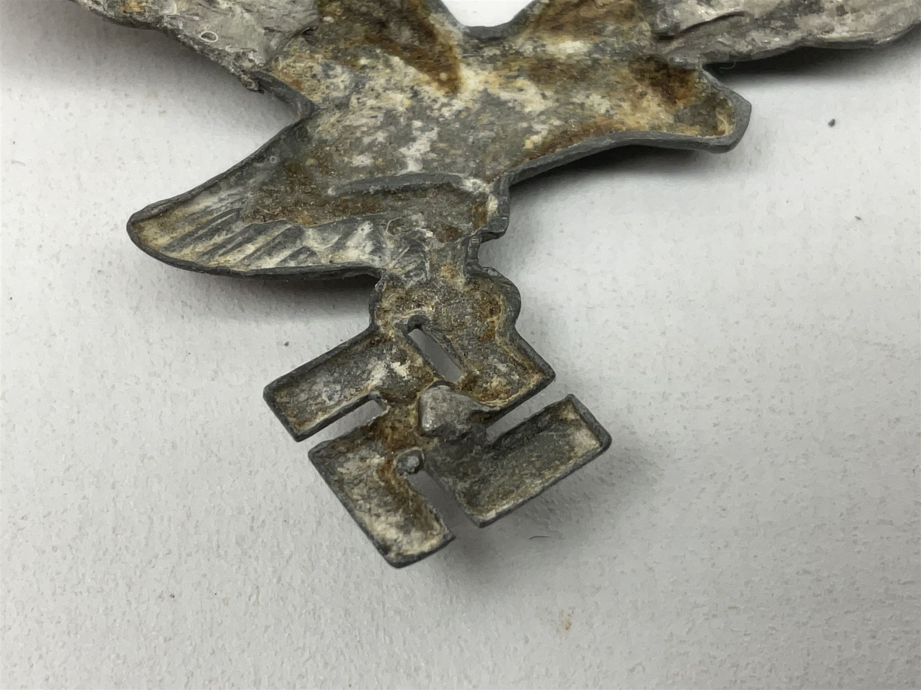 Five WW2 German peaked cap badges, four with double-pinned backs