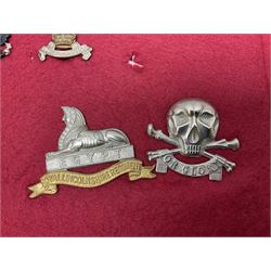 Forty glengarry and cap badges and shoulder titles including Gordon Highlanders, Canada and Canadian Field Artillery, New Zealand Field Artillery and Rifle Regiment, Shropshire Light Infantry, 14th/20th Kings Hussars, 17th Lancers, Northamptonshire Yeomanry, Royal Lincolnshire, Special Air Service, 19th Alexandra P.W.O. Hussars etc; mounted on two boards for display (2)