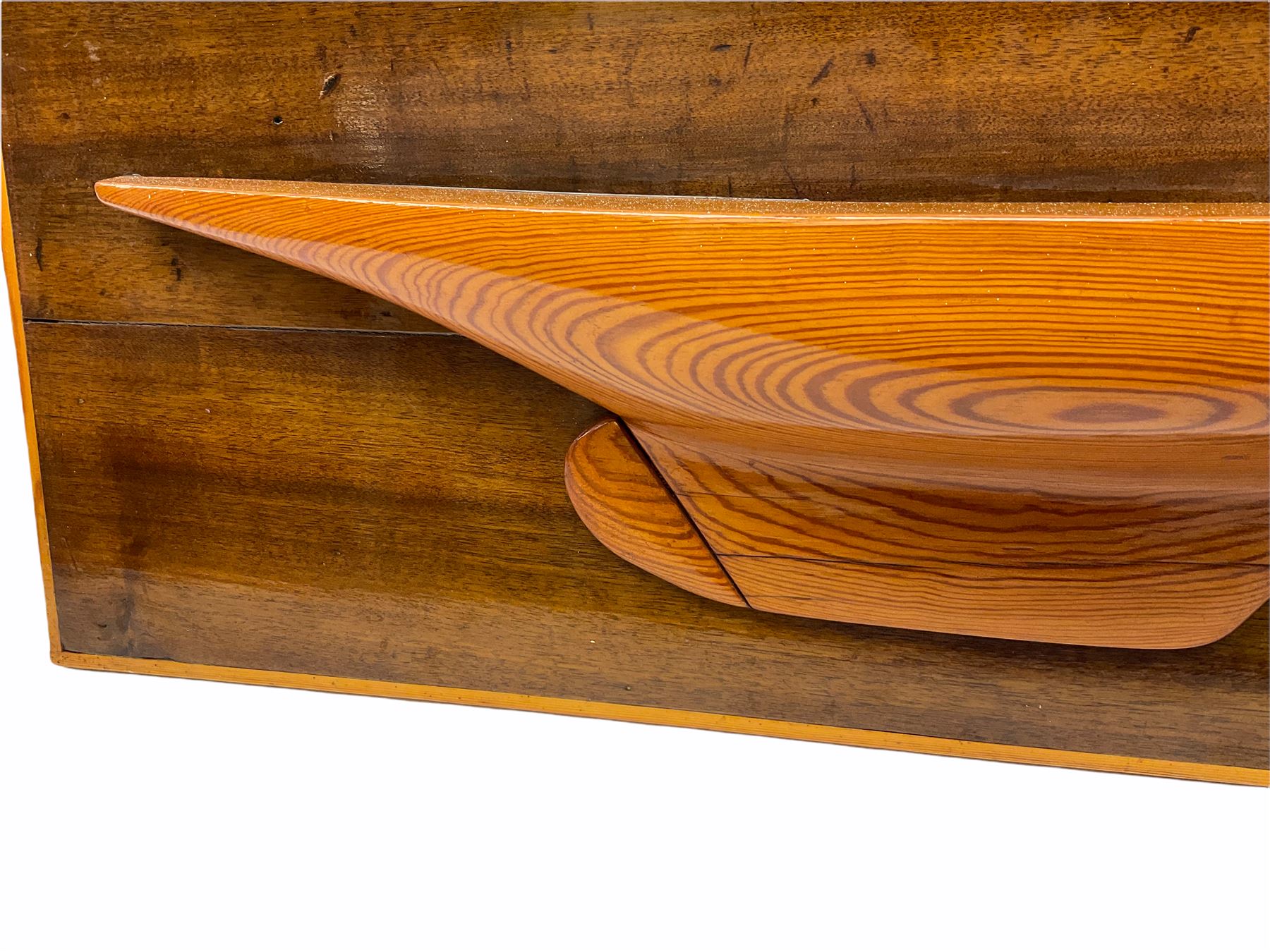 Ship builders half block pitch pine hull model upon mahogany backboard, bearing plaque 'Troll 1905', L103.5cm H35cm