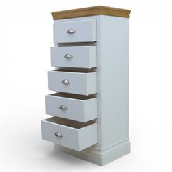 Modern narrow chest of five drawers in white finish with oak moulded top, with metal cup handles raised on a moulded plinth base