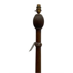Early 20th century oak standard lamp base, of baluster form with fluted acorn finial and carved foliate decoration to the base, raised on circular plinth with bun feet