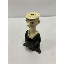 Early 20th Century painted cast iron 'Tough Nut' table top percussion nutcracker in the form of a sailor seated on lobster pot