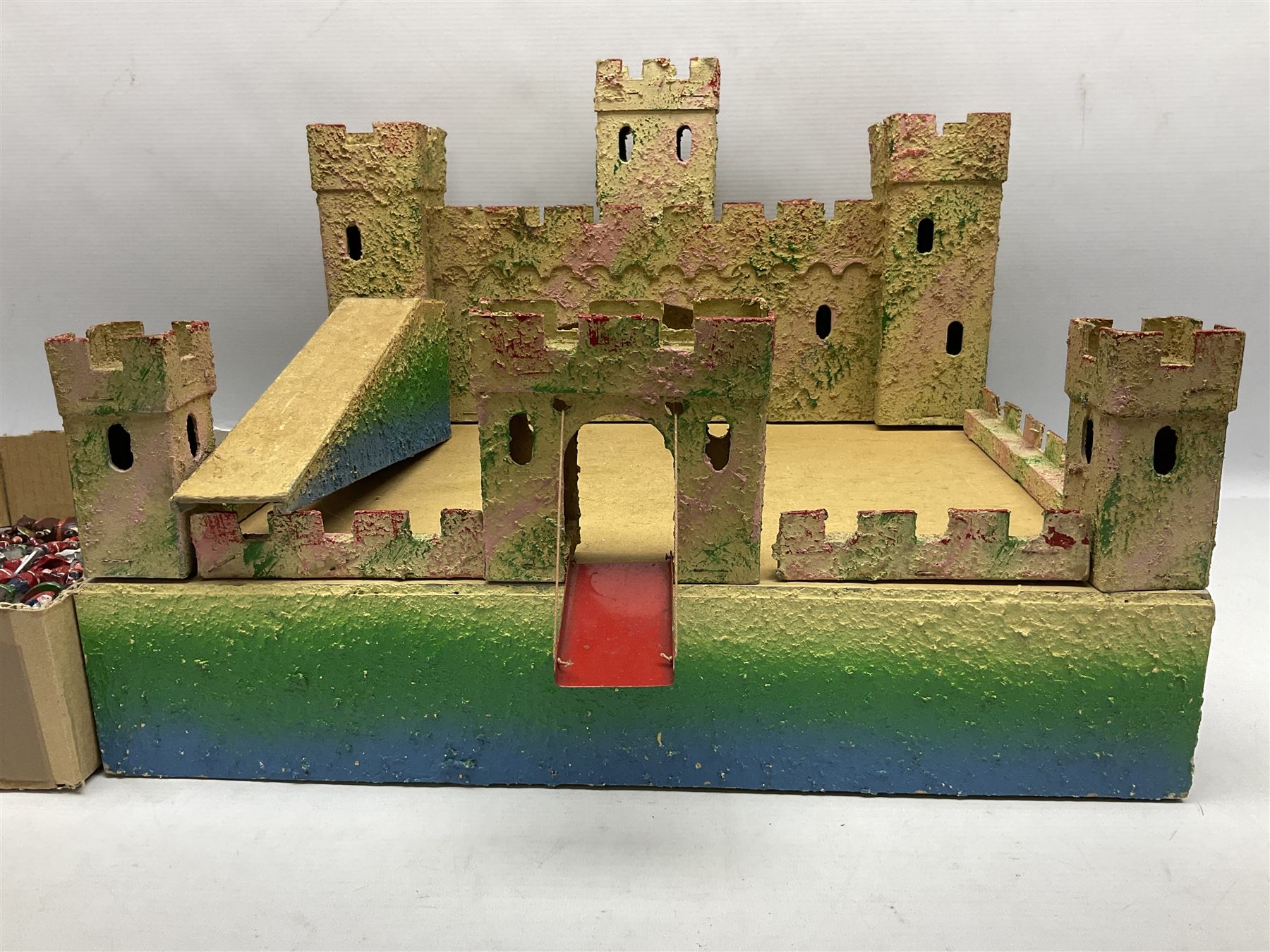 Sectional wooden fort on base with painted textured finish 46 x 36cm; together with over thirty lead and die-cast white metal soldiers and horses by various makers; and a small quantity of plastic figures of soldiers