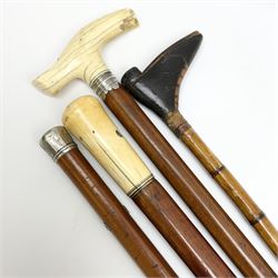 Group of walking canes, late 17th century and later, to include an example with naively carved handle modelled as a boot, another with ivory handle and unmarked white metal collar, etc. 