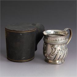 Victorian silver christening mug, of circular form with C scroll handle, embossed with scrolls and foliate decoration, with vacant oval cartouche to body, hallmarked John Aldwinckle & Thomas Slater, London 1890, contained within a tooled leather fitted case, mug H8cm