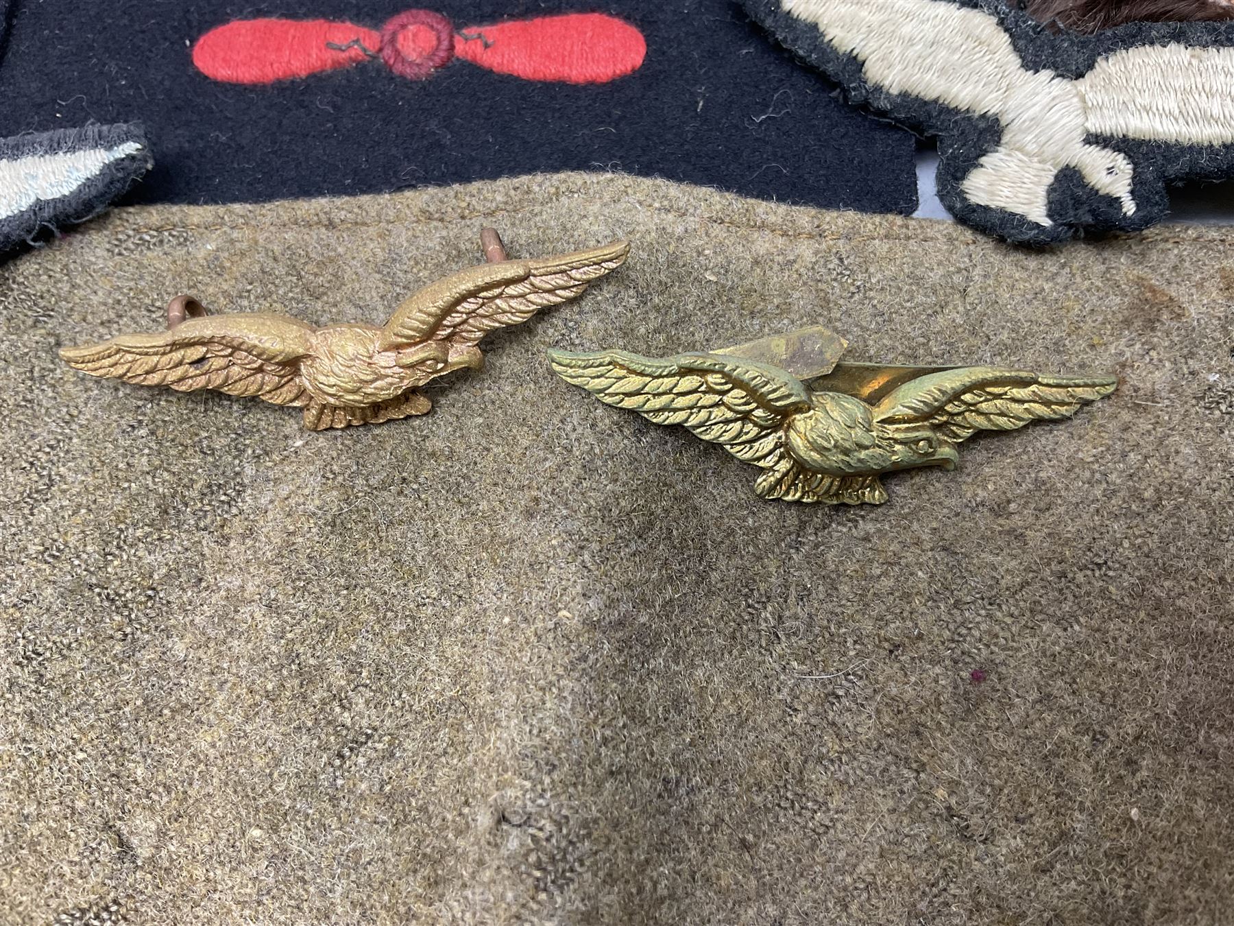 WW1 British Army Derby Scheme 1915 Attested armband; beret with East Yorkshire cap badge; pair of fur lined leather flying/motorcycle goggles; HMS Pembroke cap band; and small quantity of RNAS cloth and metal badges etc