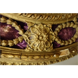  Pair 19th century ornate giltwood and gesso oval girandoles, ribbon moulded pediment with scrolls and flower heads, oval bevelled mirror plate surmounted by trailing foliage on purple velvet, three scones, 48cm x 102cm  
