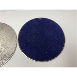 Set of eight silver plated placemats, each of circular form with engraved scroll and floral decoration, including two larger and six smaller examples, largest D23cm, in fitted case 