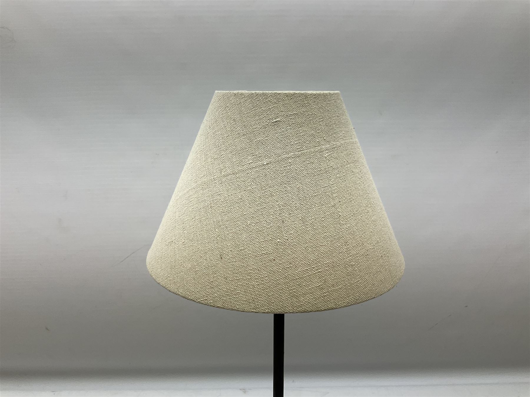 Table lamp, with a thin central stem upon a square stepped base, natural linen shade