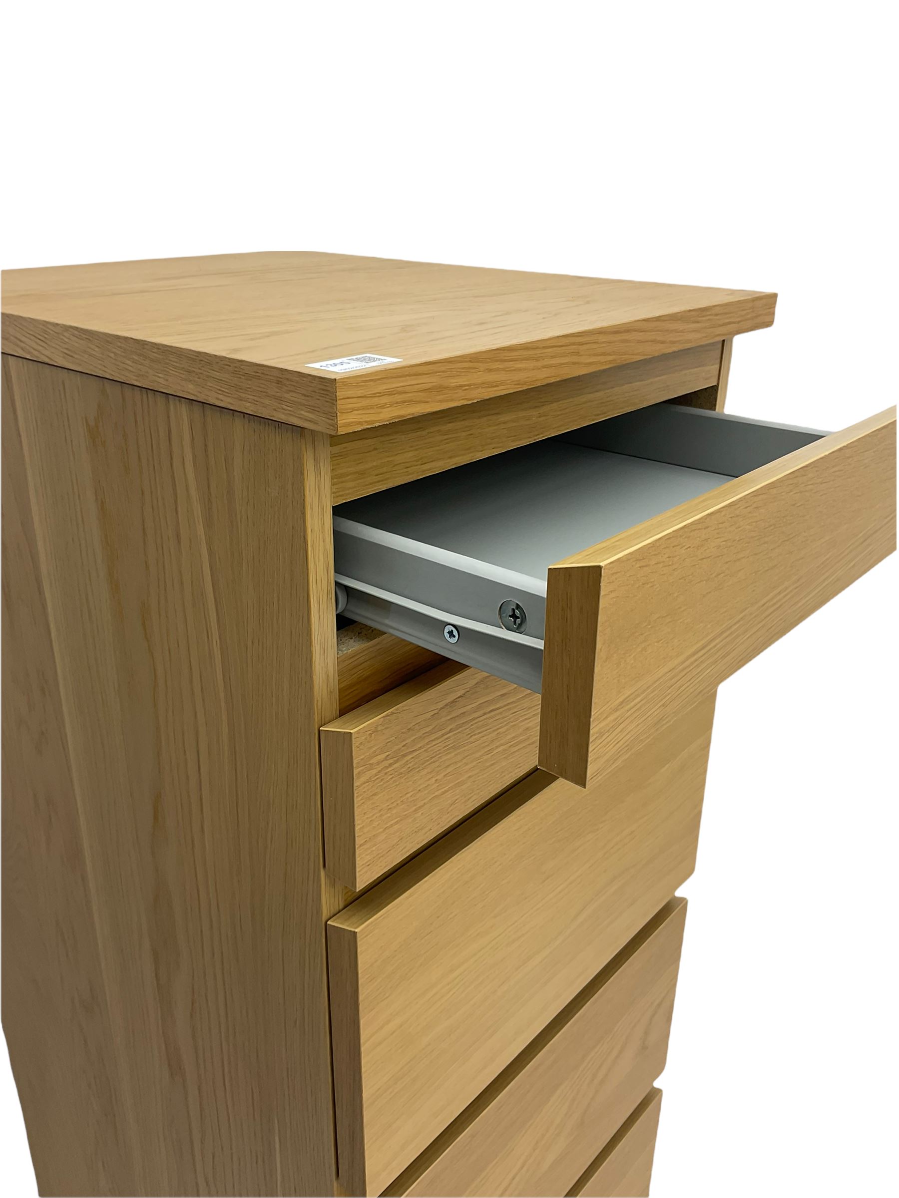 IKEA light oak finish chest, fitted with hinged vanity top, above six graduating drawers 