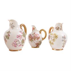 Five Royal Worcester Blush Ivory jugs, shape 1094, each decorated with floral sprigs and with gilt handles , all with puce mark to base, tallest H18cm